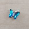 DIJE DE ACERO MARIPOSA DE ACRÍLICO AZUL TORNASOL. 15 X 20 MM