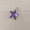 DIJE DE ACERO ESTRELLA 20 MM DE ACRÍLICO COLOR VIOLETA. 20 MM
