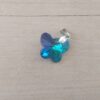 DIJE DE ACERO MARIPOSA DE ACRÍLICO TORNASOL TURQUESA. 18 X 15 MM