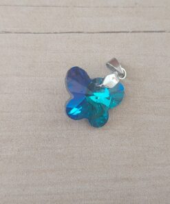 DIJE DE ACERO MARIPOSA DE ACRÍLICO TORNASOL TURQUESA. 18 X 15 MM