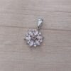 DIJE DE ACERO FLOR CON CUBIK Y STRASS ROSA. MEDIDA 15 MM