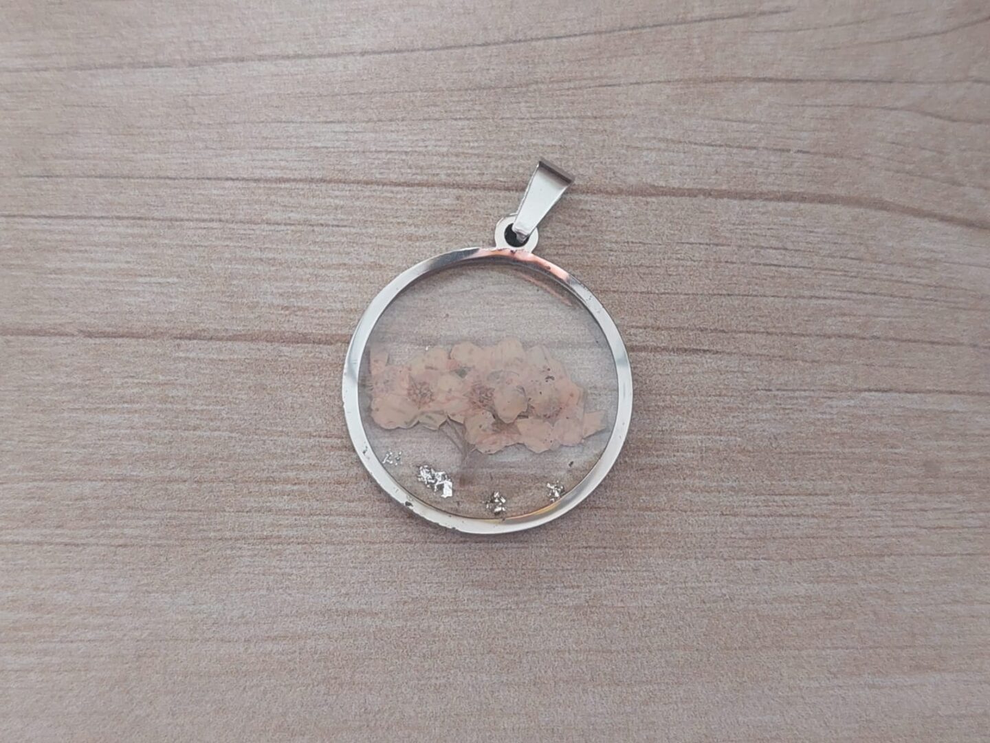 DIJE DE ACERO FLOR BEIGE EN RESINA TRANSPARENTE 25 MM