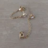 Aro de acero dorado pasante corazón con strass blanco central y cadena colgante unida a fru fru