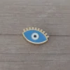 dije de acero dorado ojo