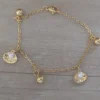 pulsera de acero dorado ostras y bolitas