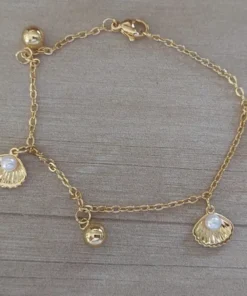 pulsera de acero dorado ostras y bolitas