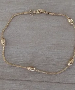 pulsera de acero dorado bolitas