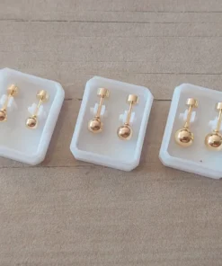 Abridor acero dorado bolita