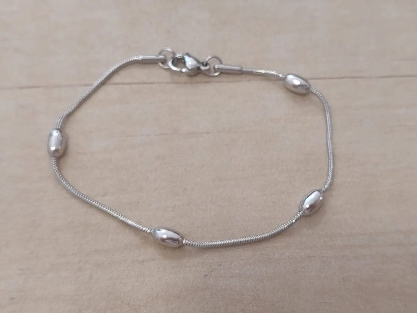 PULSERA DE ACERO COLA DE RATÓN 1.2 MM CON BOLITAS OVALADAS. LARGO 17,5 CM