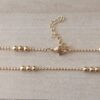 CADENA DE ACERO DORADO BOLITA 2.4 CON BOLITAS 3 MM INTERCALADAS DE A TRES.
