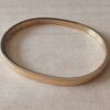 PULSERA DE ACERO DORADO ESCLAVA OVALADA CON BISAGRA 4 MM.