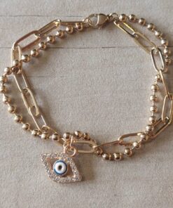 PULSERA DE ACERO DORADO DOBLE ESLABONES ALARGADOS/BOLITA CON DIJE OJO TURCO CON STRASS. LARGO 18 CM