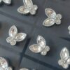 BLISTER DE AROS DE ACERO MARIPOSA CON STRASS X 12 PARES.