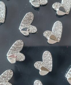 BLISTER DE AROS DE ACERO CORAZÓN CON STRASS CON CORAZON METAL SUPERPUESTO X 12 PARES.