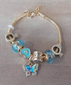 PULSERA DE ACERO DORADO COLA DE RATÓN 3 MM CON DONAS GAMA CELESTE Y MARIPOSA. LARGO 19 CM EXT. 3 CM