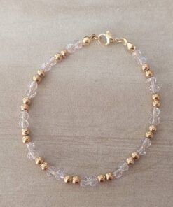 PULSERA DE TANZA CON DOS MOSTACILLAS ROSAS Y DOS BOLITAS 3 MM INTERCALADAS. TERMINAL DE ACERO DORADO. LARGO 18,5 CM.