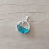 DIJE LAMINADO EN PLATA LUNA Y ESTRELLA CUN CUBIKS Y MAR ACRILICO COLOR TURQUESA . TAMAÑO 15 MM