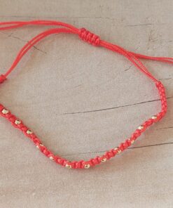 PULSERA DE HILO ROJO CON BOLITAS DE ACERO DORADO AJUSTABLE.