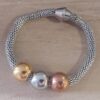 PULSERA DE ACERO MALLA TUBULAR TEJIDA 6 MM CON CIERRE IMANTADO Y DONAS TRES ACEROS. LARGO 20 CM
