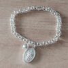 PULSERA DE ACERO BLANCO ROLO 5.0 CON DIJE SAN BENITO OVAL Y BOLITA 8 MM. LARGO 18 CM
