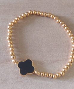 PULSERA DE ACERO DORADO ELASTIZADA CON BOLITAS 3 MM Y DIJE CENTRAL ESTILO VAN CLEEF NEGRO.