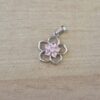 DIJE DE ACERO FLOR CALADA CON STRASS ROSA . MEDIDA 17 MM