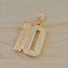 DIJE DE ACERO DORADO NUMERO 10 CON STRASS. TAMAÑO 29 X 52 MM