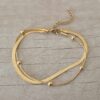 PULSERA DE ACERO DORADO VÍBORA CHATA COMBINADA CON CLAPTON CON BOLITA. LARGO 19 CM + EXT. 4,5 CM.