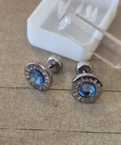 ABRIDOR DE ACERO REDONDO CON BORDE GRABADO Y STRASS CELESTE
