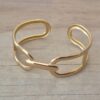 PULSERA DE ACERO DORADO ESCLAVA ABIERTA TRABAJADA