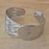 PULSERA DE ACERO ESCLAVA ABIERTA TRABAJADA