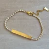 PULSERA DE ACERO DORADO TIRA DE STRASS 3.5 MM BLANCO, CON CHAPA 32 X 5 MM PARA GRABAR. LARGO 18 + 5 CM EXT.