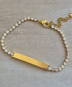 PULSERA DE ACERO DORADO TIRA DE STRASS 3.5 MM BLANCO, CON CHAPA 32 X 5 MM PARA GRABAR. LARGO 18 + 5 CM EXT.
